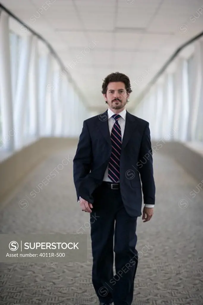 Portrait of businessman standing in corridor