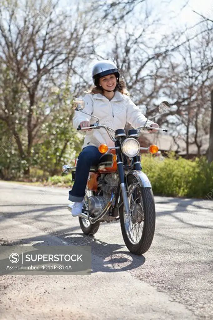 Teenage girl riding motorcycle