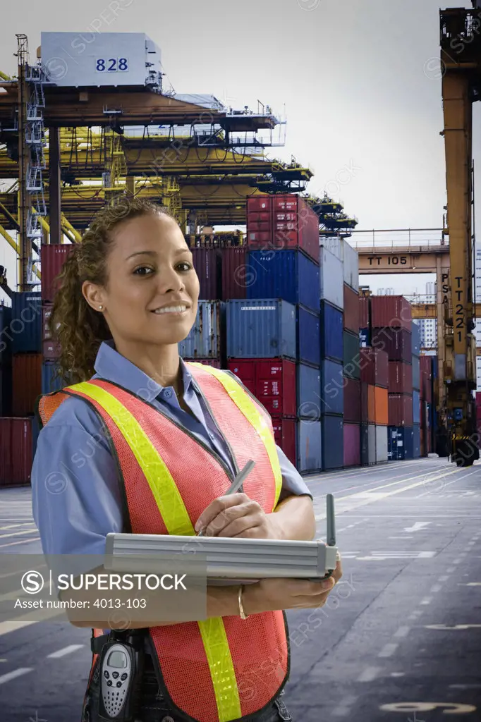 Dock worker standing with a digital inventory pad at commercial dock