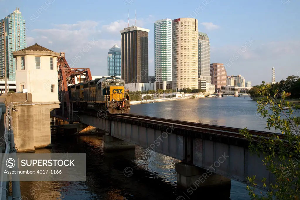 Freight Train crossing bridge with Tampa Skyline from Hillsborough River