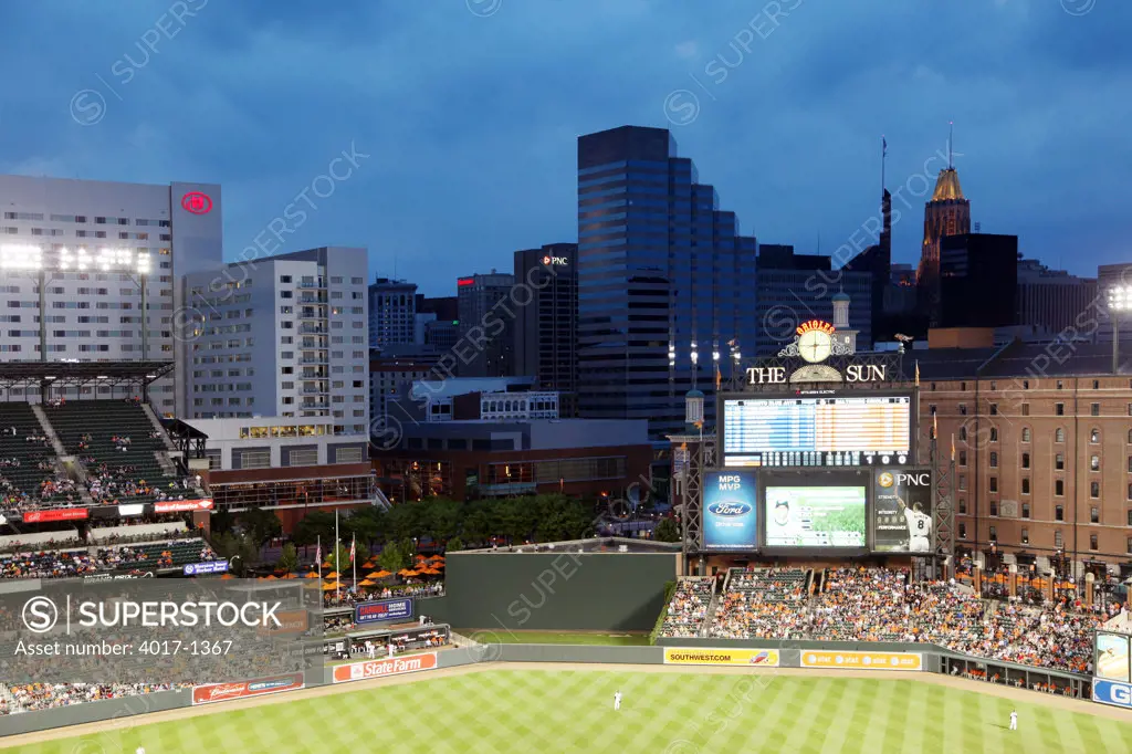 The Baltimore Skyline behind the outfield of Oriole Park at Camden Yards at dusk