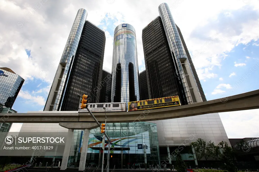 Entrance to the GM Headquarters Building in Detroit, Michigan with a people mover passing by
