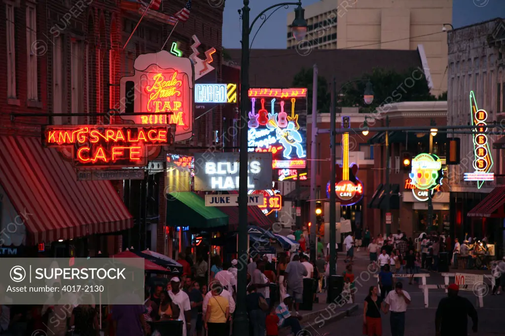 Resturants and Stores on Beale Street at Night with Pedestrian Activity