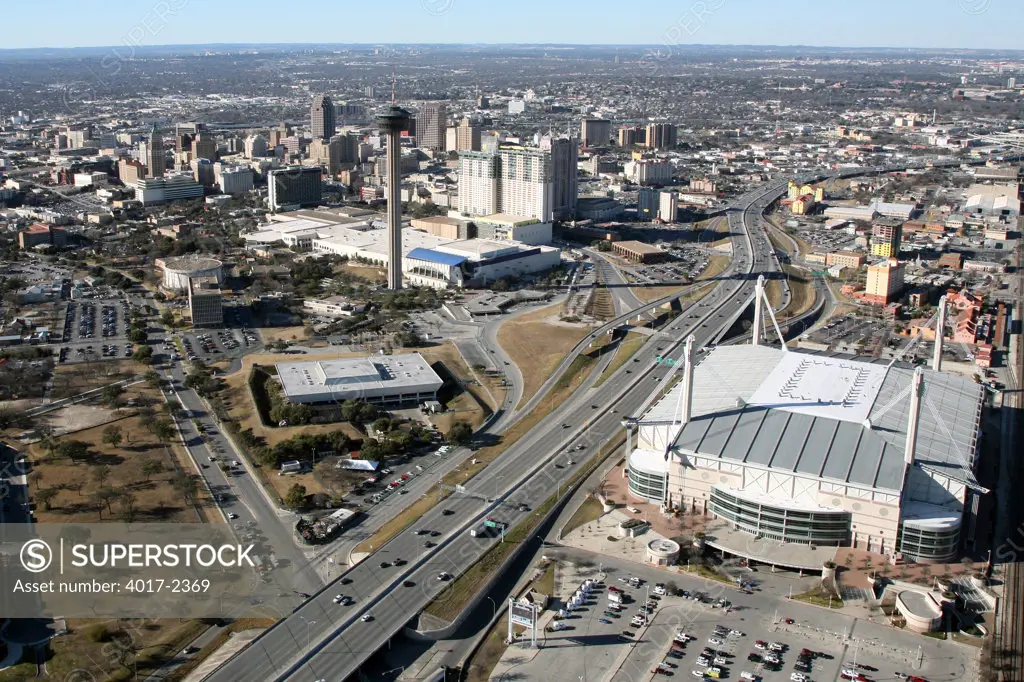 Aerial of The Alamodome with the Tower of the Americas and Henry B. Gonzalez Convention Center and the Downtown San Antonio, Texas Skyline in the Background