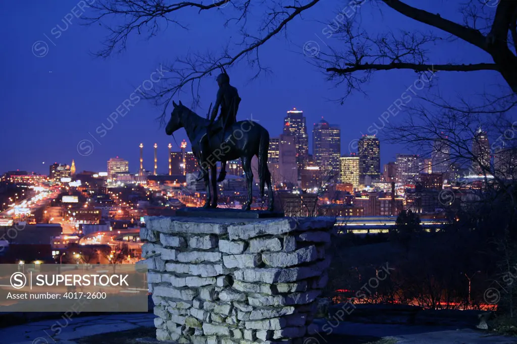 The Scout statue in Penn Valley Park overlooking downtown Kansas City at night, Missouri, USA