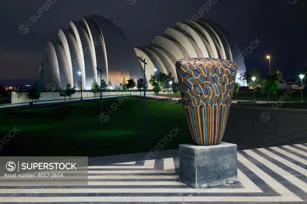 The Kauffman Center for the Performing Arts behind a sculpture at the Bartle Hall Convention Center in downtown Kansas City, Missouri, USA