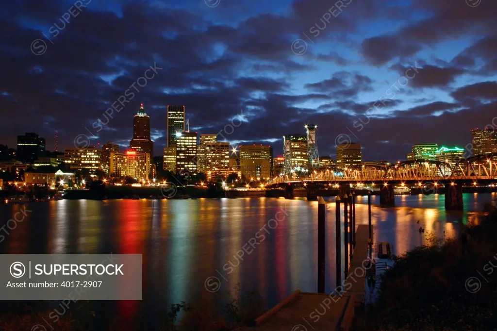 Downtown Portland skyline and the Hawthorne Bridge from across the Willamette River at night, Oregon, USA
