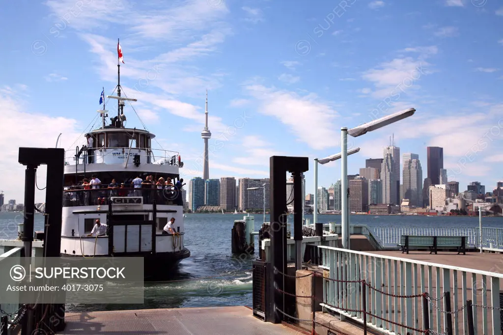 Ferry at a dock with city skyline in the background, Lake Ontario, Toronto, Ontario, Canada