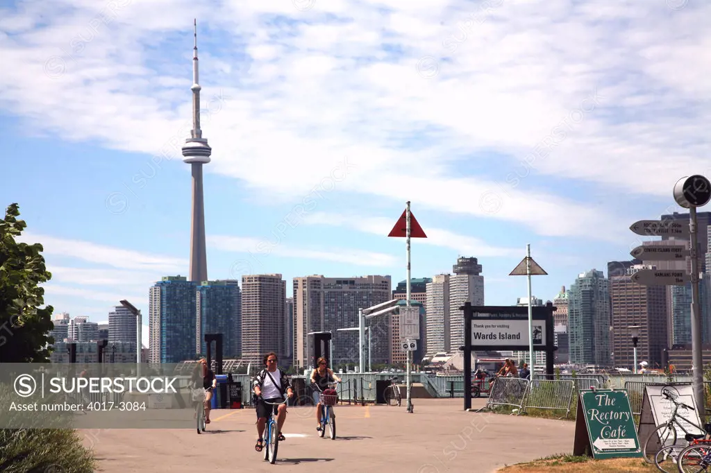 People cycling with downtown skyline in the background, Toronto Island, CN Tower, Toronto, Ontario, Canada