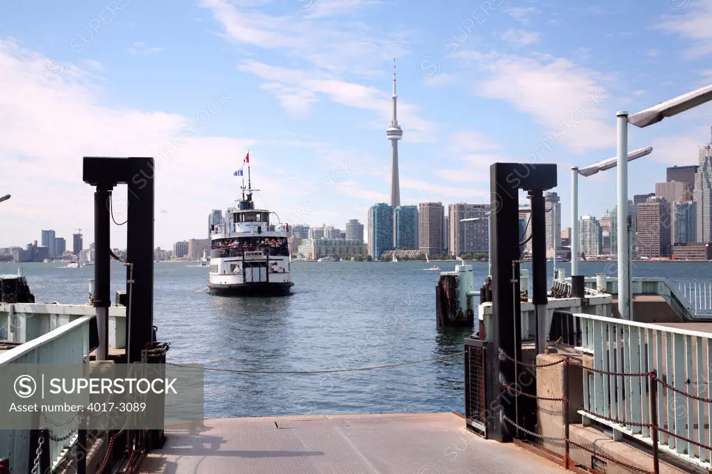 Ferry coming in to dock with skylines in the background, Lake Ontario, Toronto Island, Toronto, Ontario, Canada