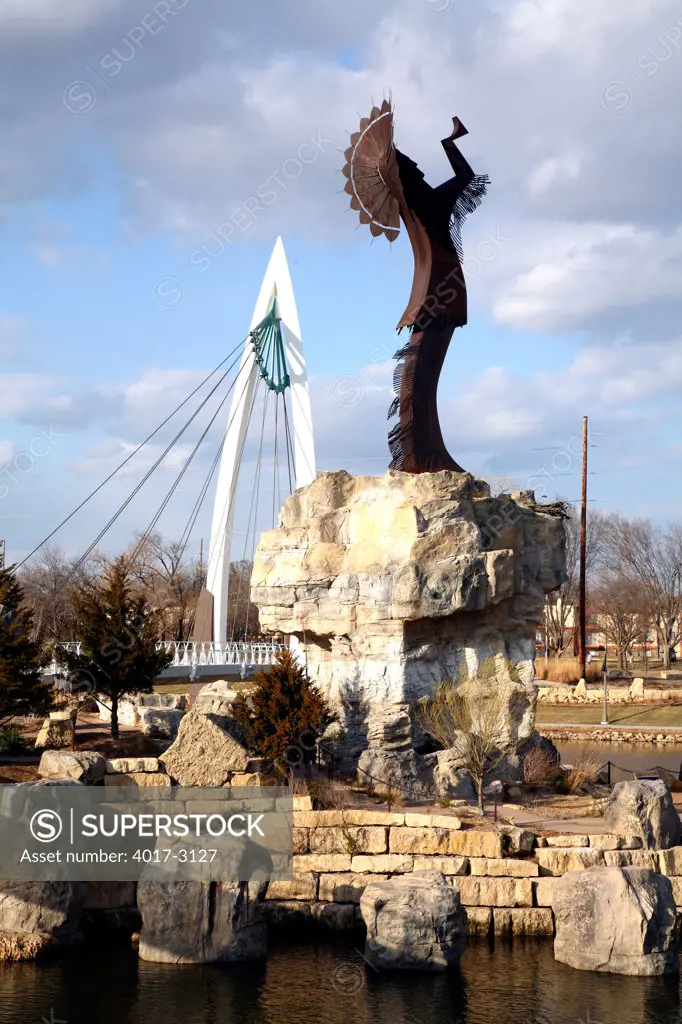 Keeper Of The Plains sculpture in front of Wichita Riverfront Pedestrian Bridge, Wichita, Kansas, USA