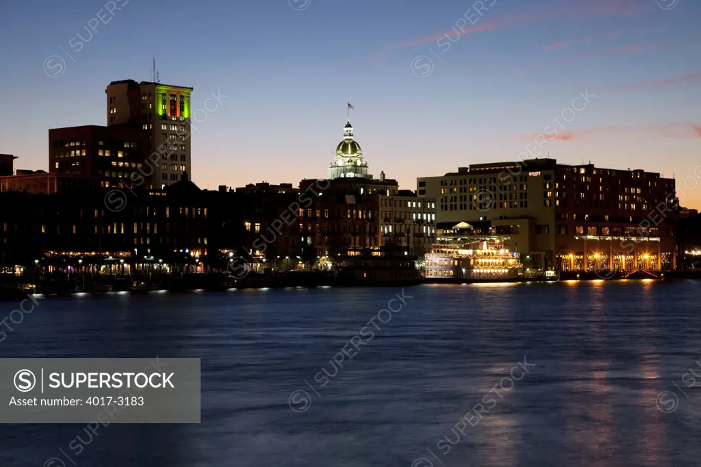 USA, Georgia, Savannah, Skyline along historic riverfront at dusk
