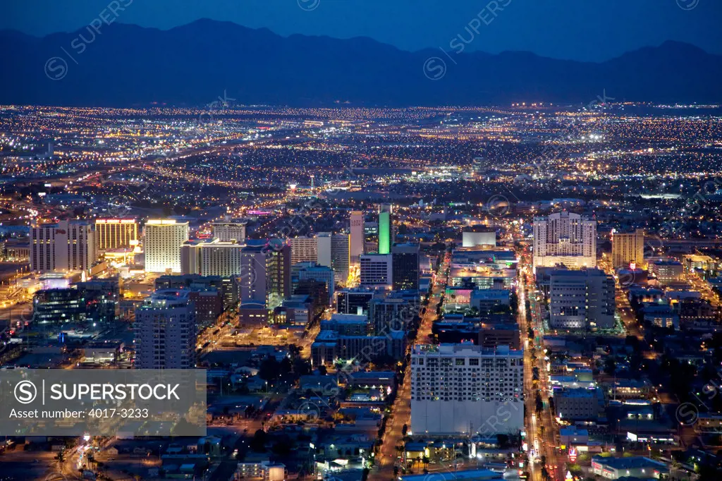 Downtown Las Vegas skyline at night with mountains in the background, Las Vegas, Clark County, Nevada, USA