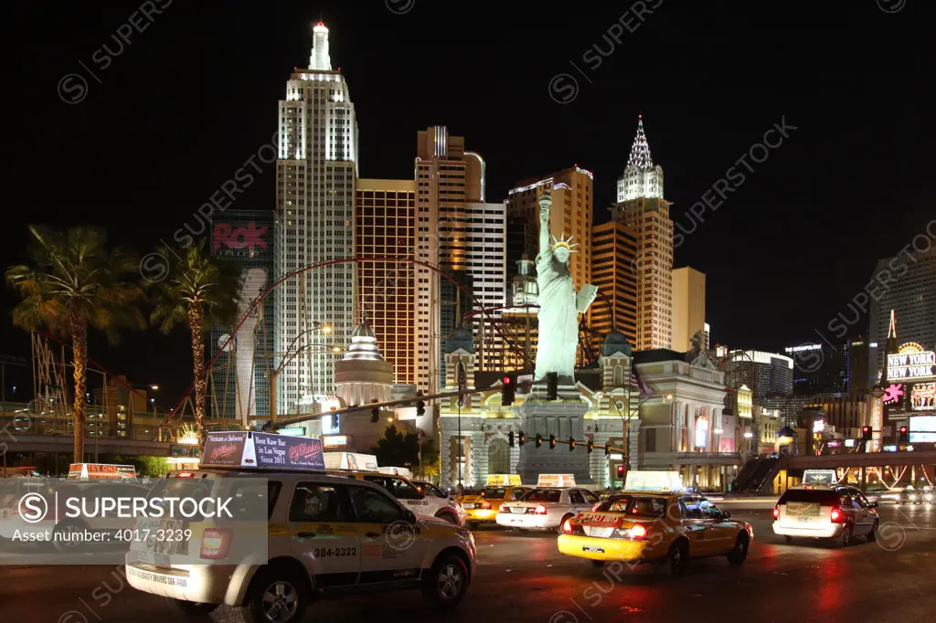 Taxi cabs on Las Vegas Boulevard with the New York New York Hotel and Casino towering over, Las Vegas, Clark County, Nevada, USA