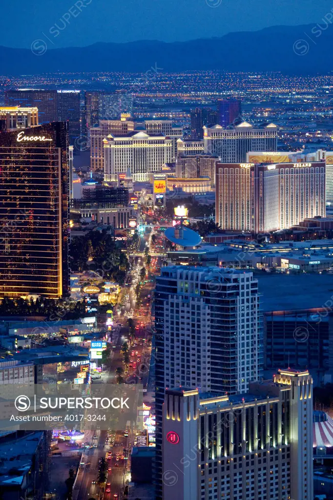Las Vegas Boulevard at dusk with the city lights and mountains in background, Las Vegas, Clark County, Nevada, USA