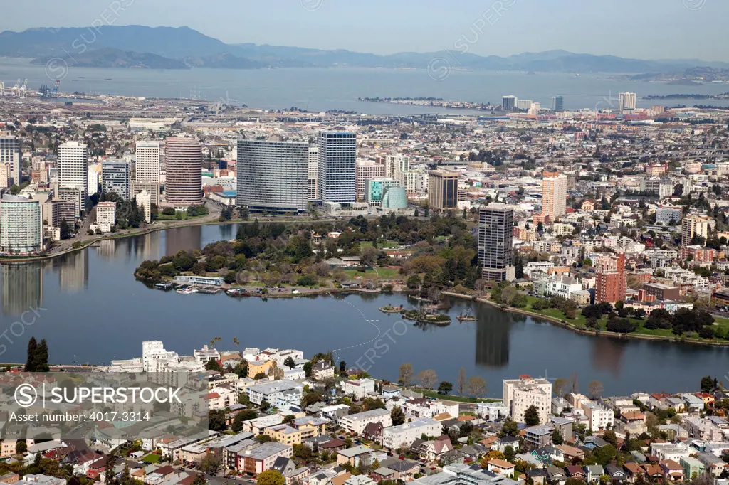 Aerial of Cleveland Heights district and Lake Merritt in Oakland, California with the Downtown Skyline and San Francisco Bay in background