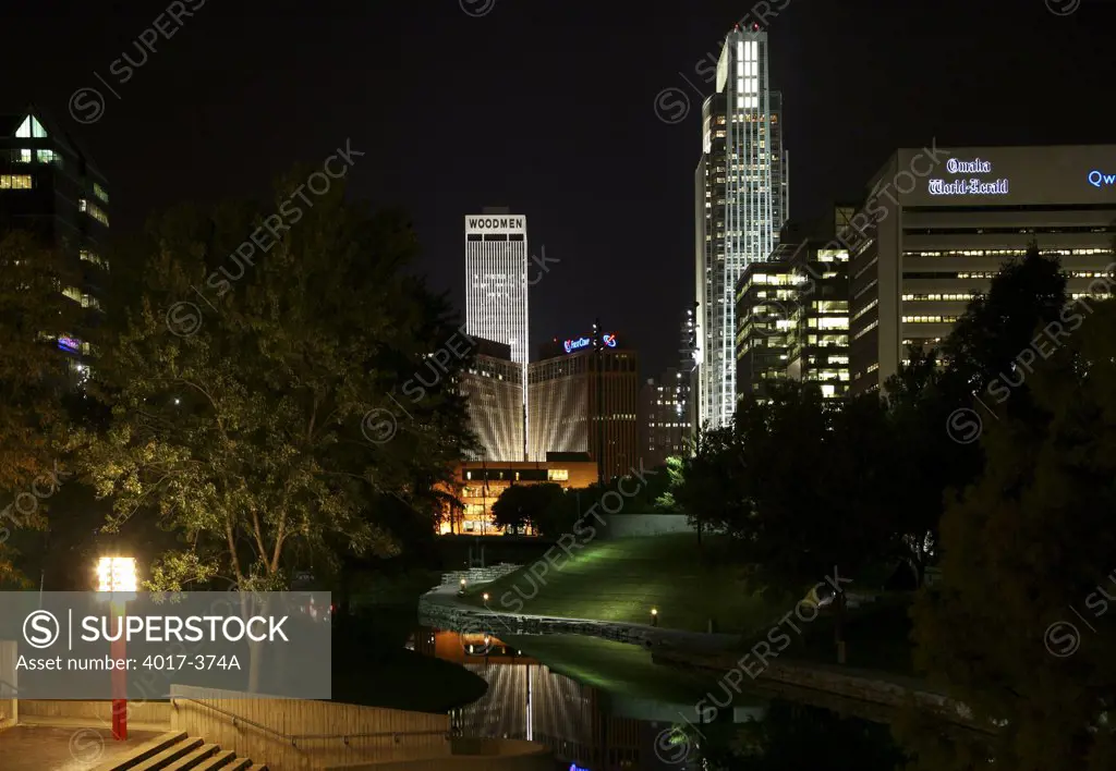 USA,   Nebraska,   Omaha,   Park at night with skyscrapers in background