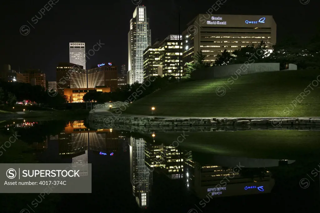 USA,   Nebraska,   Omaha,   Park at night with skyscrapers in background