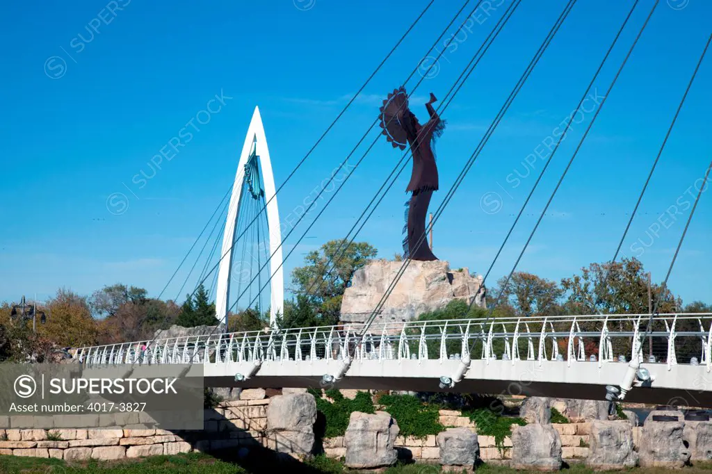 USA, Kansas, Wichita, Keeper of Plains sculpture and Arkansas River Pedestrian Bridges in Downtown