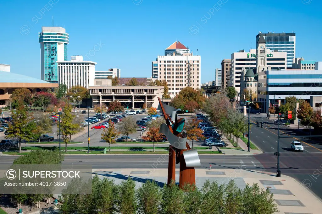 USA, Kansas, Wichita, City skyline from corner of Main and Waterman Streets with Waterwalk Sculpture designed by Albert Paley