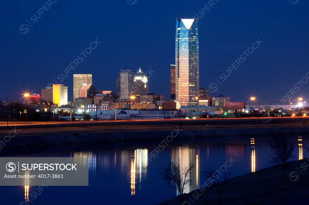 USA, Oklahoma, Oklahoma City skyline reflecting into Oklahoma River at dusk