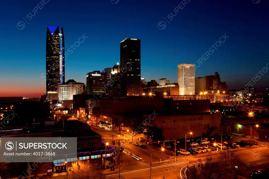 USA, Oklahoma, Oklahoma City, Sun setting behind Downtown and Bricktown
