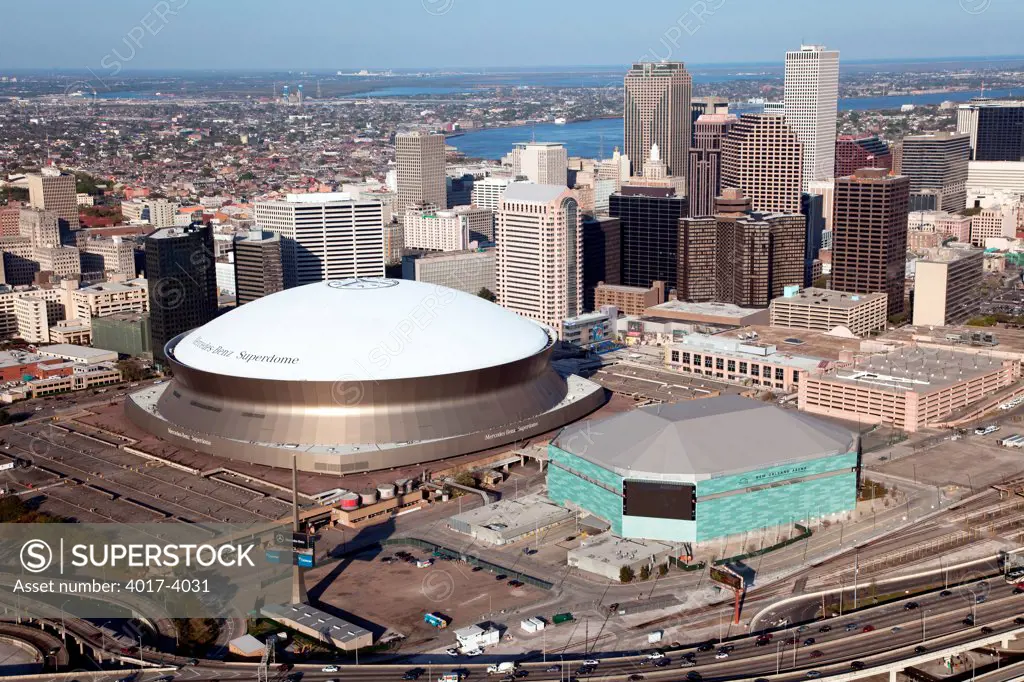 Downtown New Orleans, Louisiana from an aerial view with the Mercedes-Benz Superdome and New Orleans Arena in the foreground