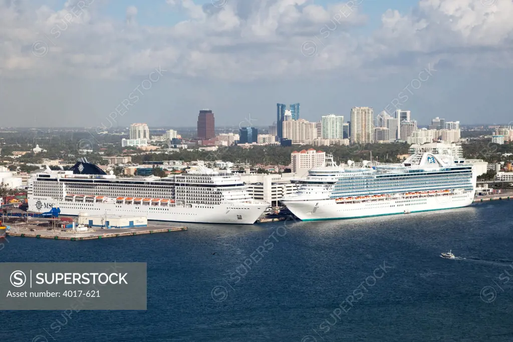 Aerial of Cruise ships docked at Port Everglades Channel with downtown Fort Lauderdale in background