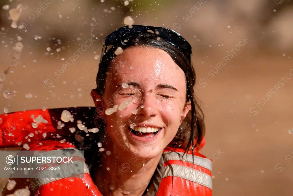 Woman getting splashed with water, Colorado River, Grand Canyon, Arizona, USA