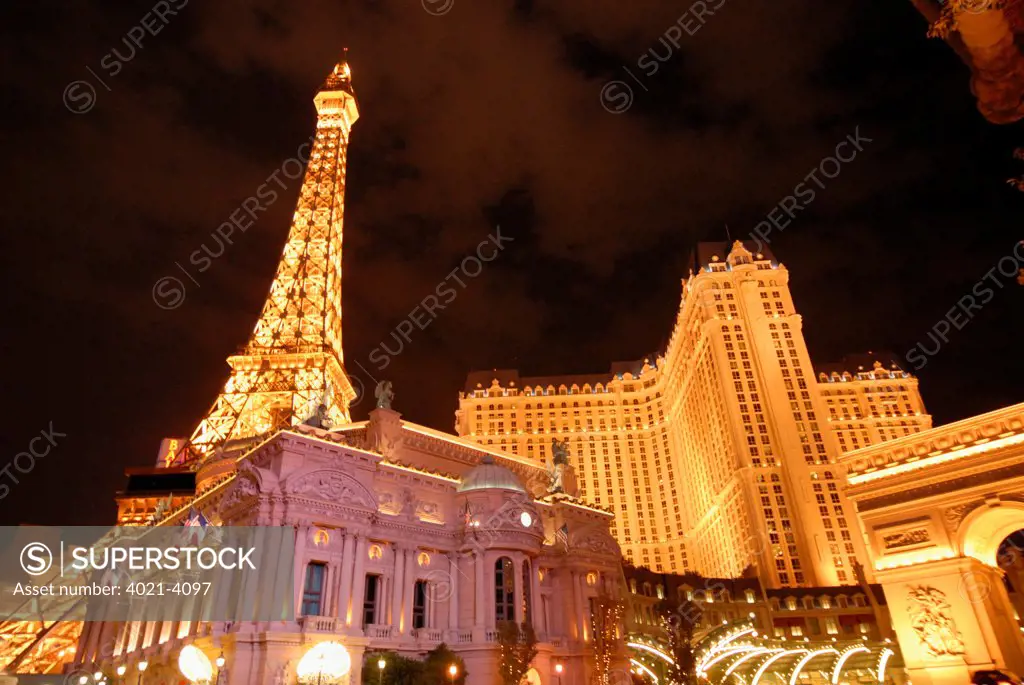 Paris Las Vegas with Replica Eiffel Tower and Replica of Arc de Triomphe lit up at night, Las Vegas, Nevada, USA