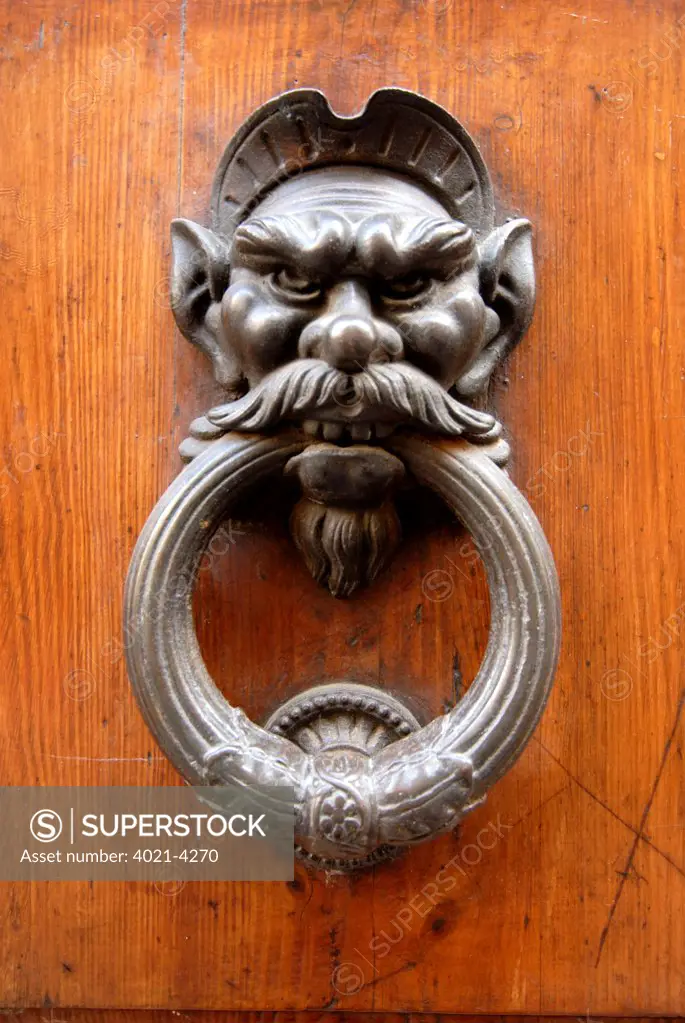 Details of an old door knocker of a historic house, San Gimignano, Siena, Tuscany, Italy