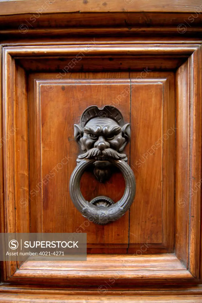Details of an old door knocker of a historic house, San Gimignano, Siena, Tuscany, Italy
