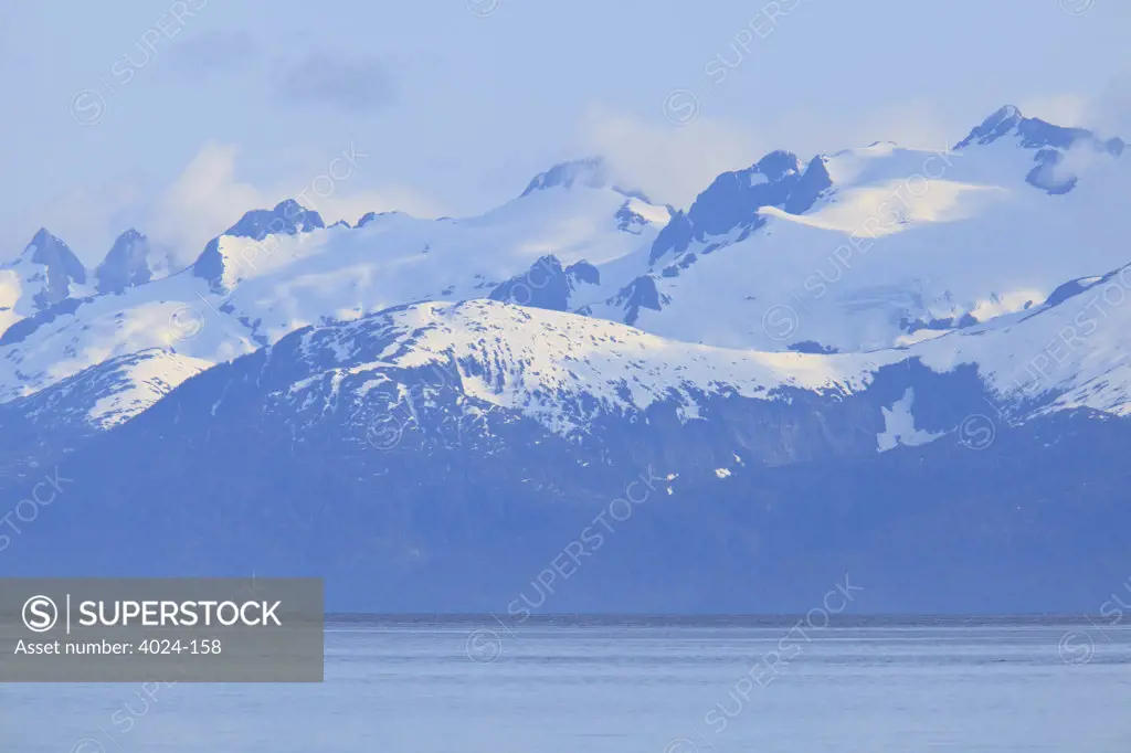 Sea with snow covered mountains in the background, Icy Strait, Alexander Archipelago, Alaska, USA