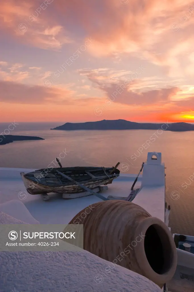 Greece, Cyclades, Santorini Island, Firostefani, Boat on roof terrace at sunset