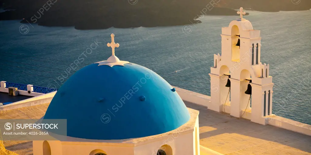 Greece, Cyclades, Santorini Island, Firostefani, Church dome and bell tower at sunset