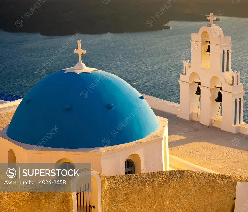 Greece, Cyclades Islands, Santorini, Firostefani, Church dome and bell tower at evening light