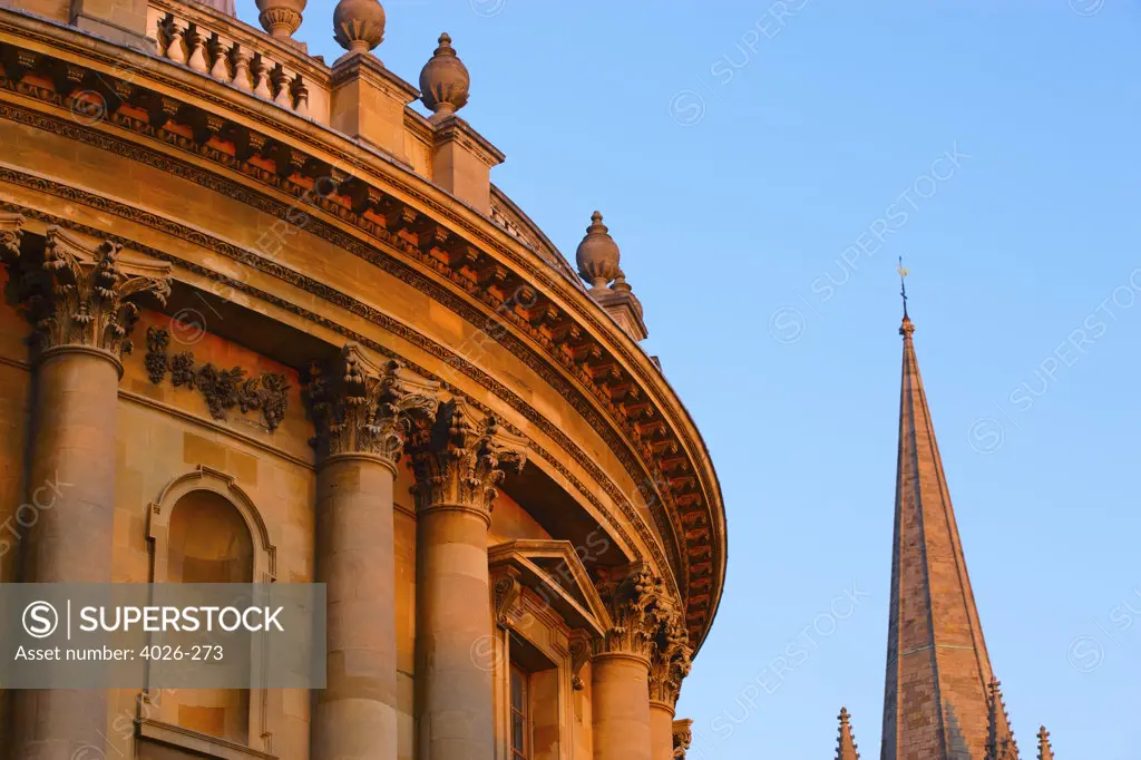Low angle view of an Educational building with a church, Radcliffe Camera, St Mary's Church, Oxford University, Oxford, Oxfordshire, England