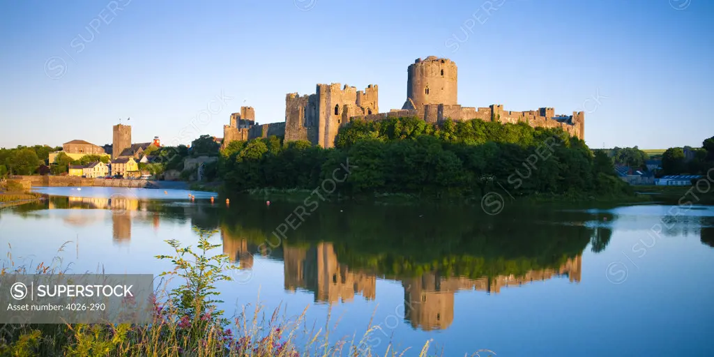 Reflection of a castle in the river, Pembroke Castle, Pembroke River, Pembroke, Pembrokeshire, Wales