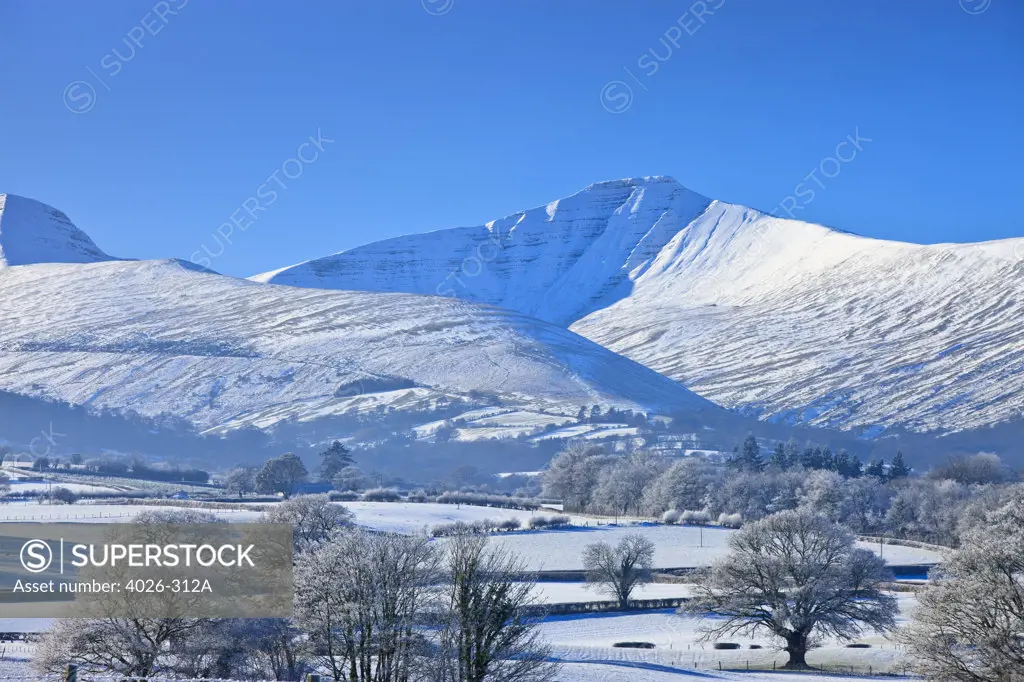 Snow covered field with mountain range in the background, Pen Y Fan, Corn Du mountains, Mynydd Illtyd Common, Brecon Beacons National Park, Powys, Wales