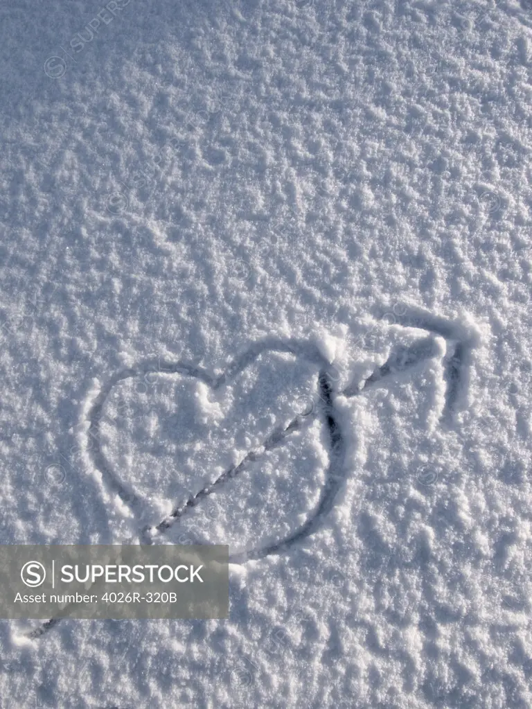 Drawing of heart and arrow in snow