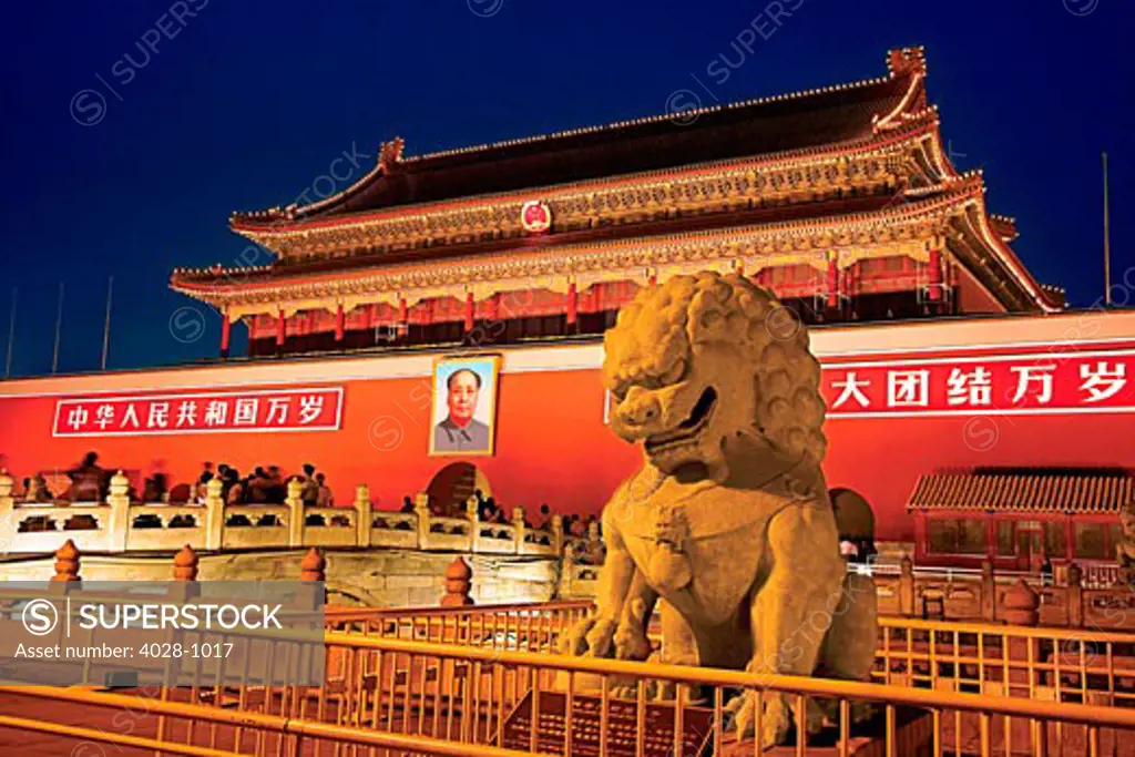 China, Beijing, The Forbidden City, Gate of Heavenly Peace, formidable stone lion guarding the entrance at the North Gate, Illuminated at night.