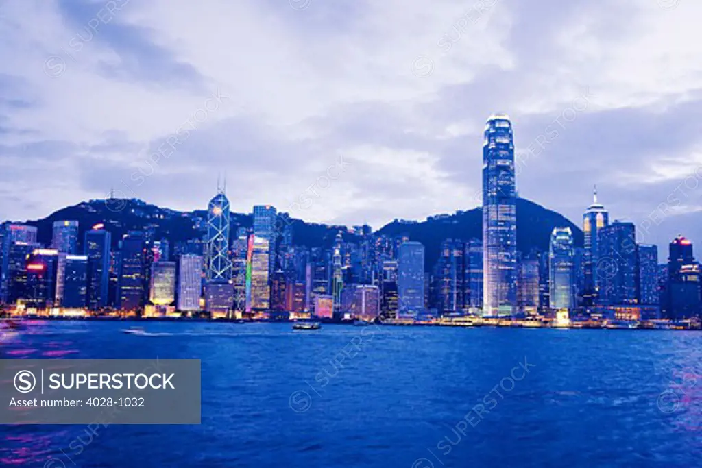 China, Hong Kong, Early evening view of the city as seen by boat from Hong Kong Harbor in the early morning.