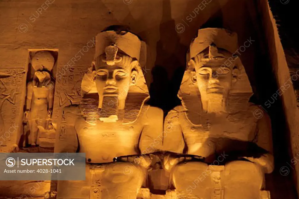 Egypt, Abu Simbel, The Greater Temple of Ramses II, Four Colossal statues of King Ramesses II near Lake Nasser during the Sound and Light Show.