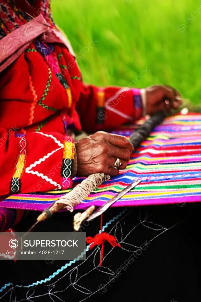Peru, Cuzco, Sacred Valley, Old Woman weaving traditional clothing