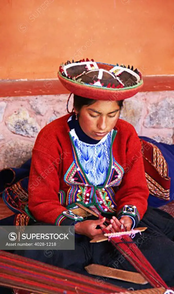 Peru, Cuzco, Sacred Valley, Woman weaving traditional clothing