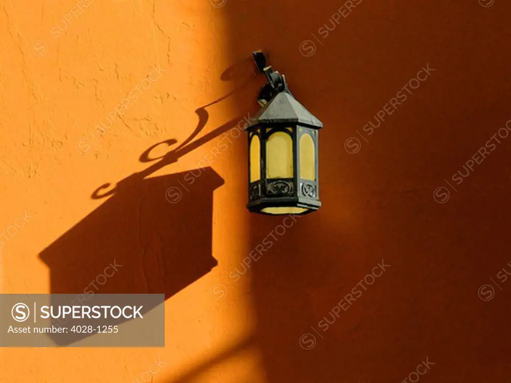 Puerto Rico, Old San Juan, ornate street lamp with typical Colonial architecture.