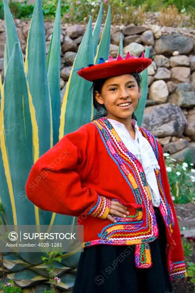 Cusco, Peru, A local girl dressed in traditional clothing poses in the Sacred Valley of Peru near the city of Cusco at a local market.