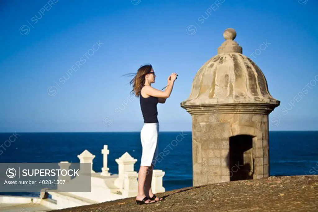 El Morro fortress and Church. Old San Juan. Puerto Rico. Woman taking a photo.