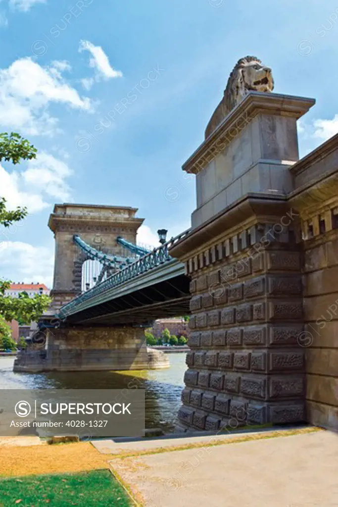 Hungary, Budapest, Szechenyi Chain Bridge, Stone Lion and the Danube River.