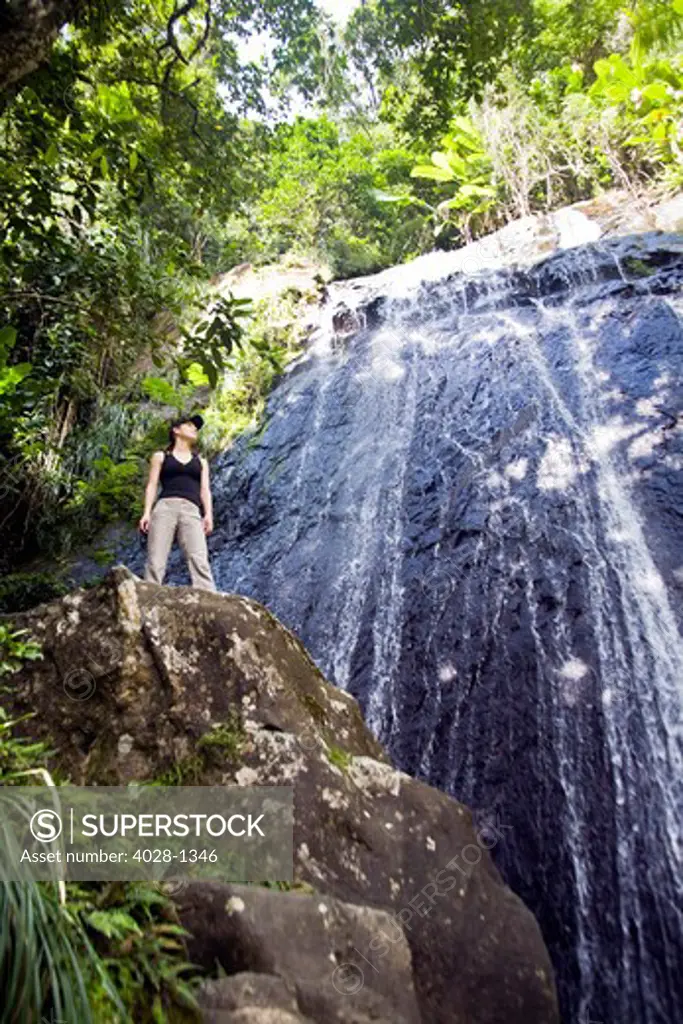 Puerto Rico, Luquillo, El Yunque National Forest, Woman at La Coca Waterfall.